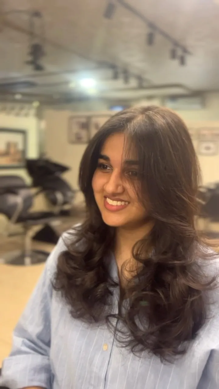 Long dark hair cut in soft, face-framing layers